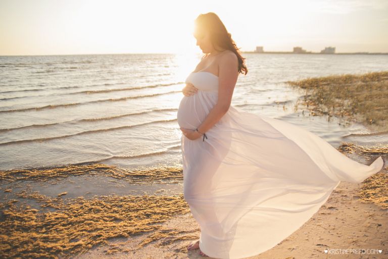 beautiful maternity portrait in maternity gown at the beach Tampa FL, Kristine Freed Photography