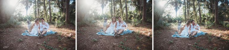 family sitting on blanket in park