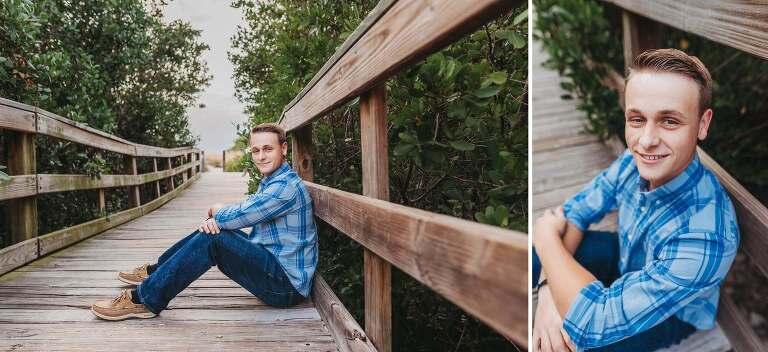 senior boy sitting on wooden walkway