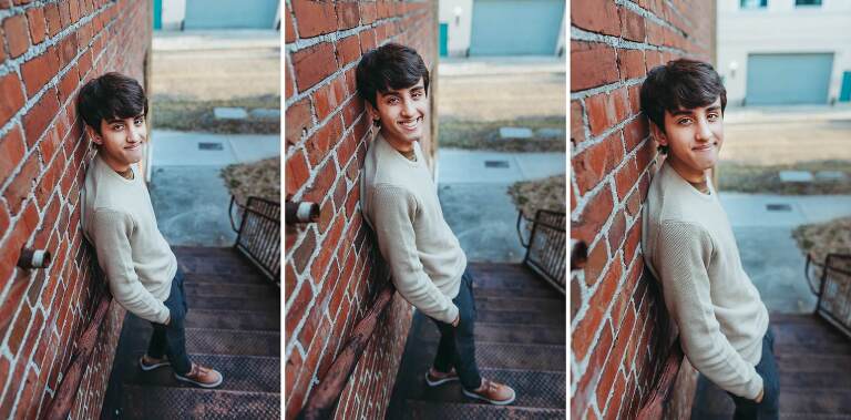 senior boy leaning against brick wall